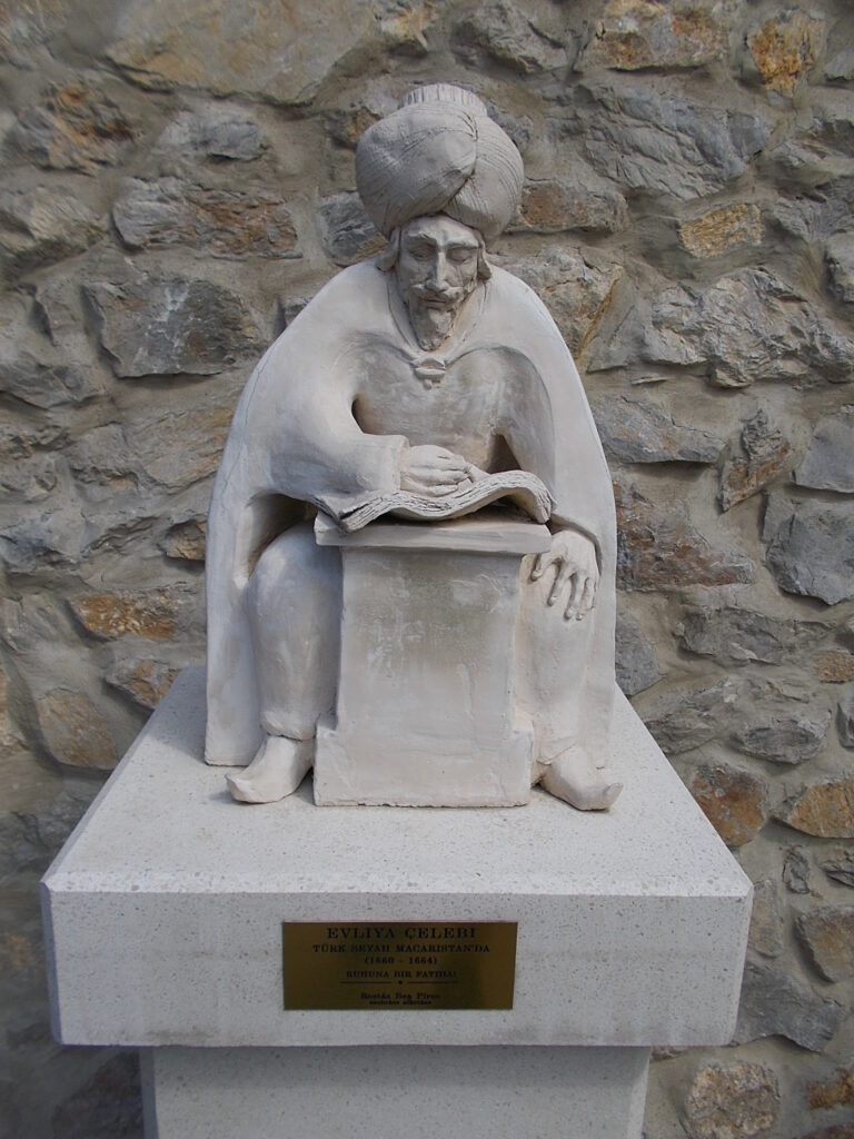 Statue of Evliya Celebi close to the Castle of Eger in a small memorial park. By Piros Rostás Bea (2014). - Eger, Heves County, Hungary. Wikimedia